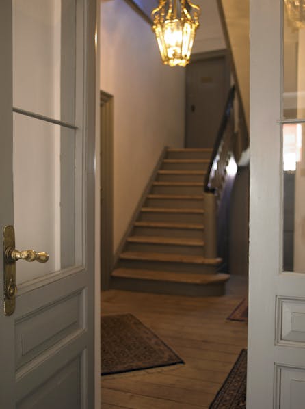 Fra hoveddøren træder man ind i et lille vindfang og videre op ad trappen, hvor Realdania By & Byg har kontorer.