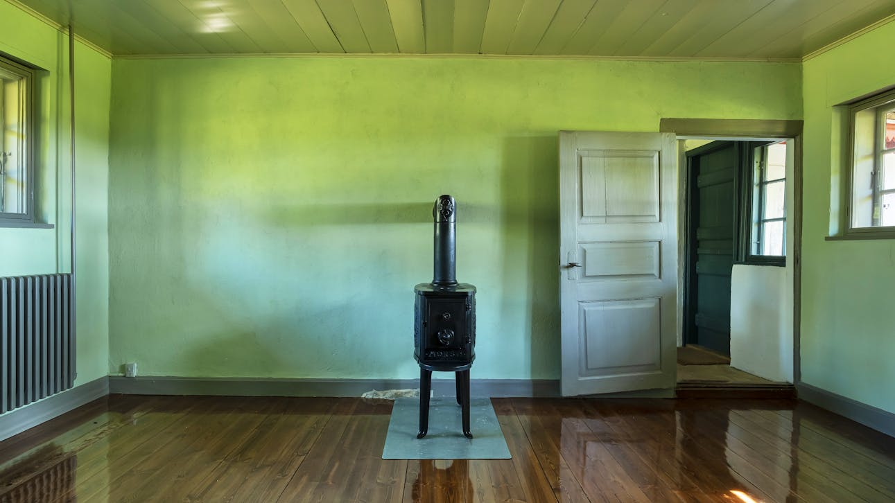 Dagligstuen med brændeovn og kig til køkkenet.